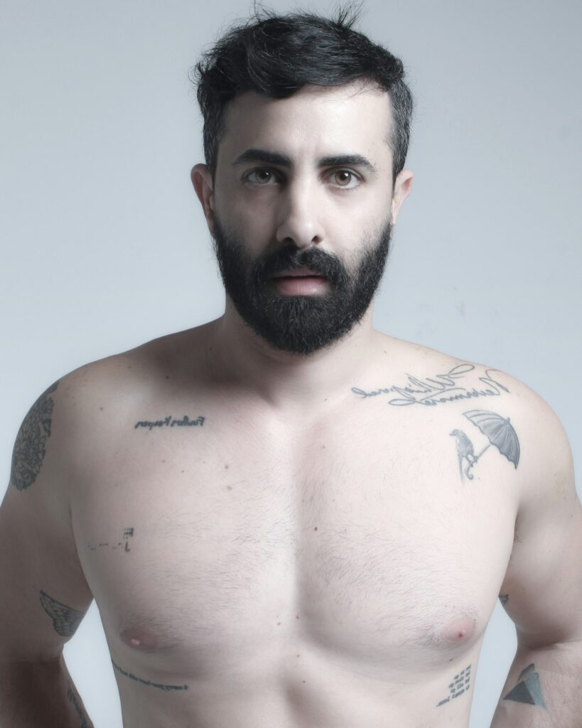 Small script tattoo on a man's chest