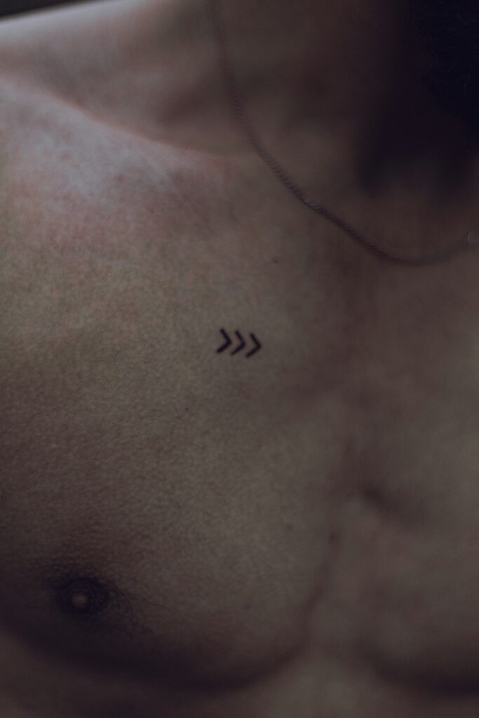 Small tattoos for guys: chevron arrows on the chest