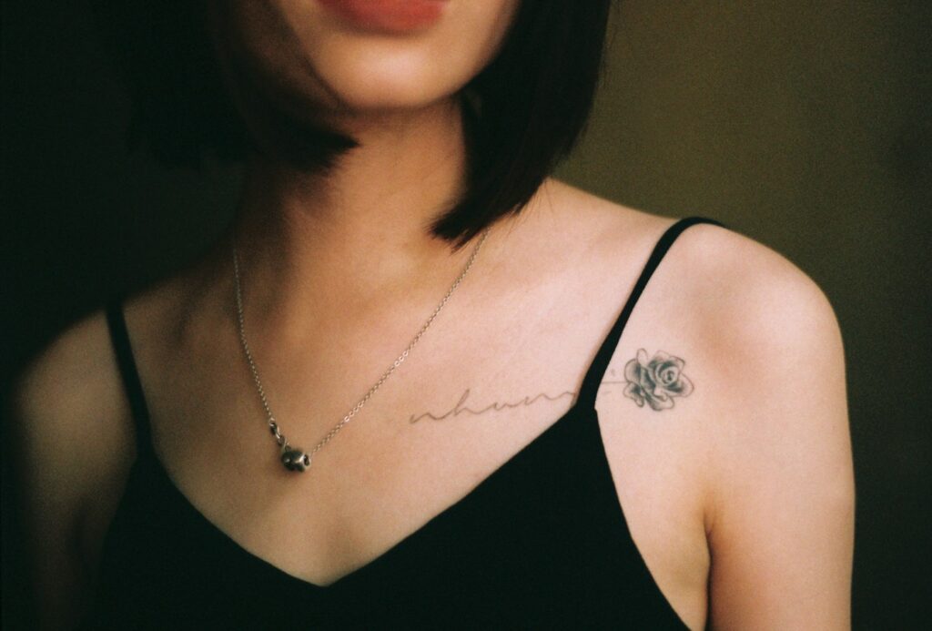 Delicate small tattoo near the collarbone