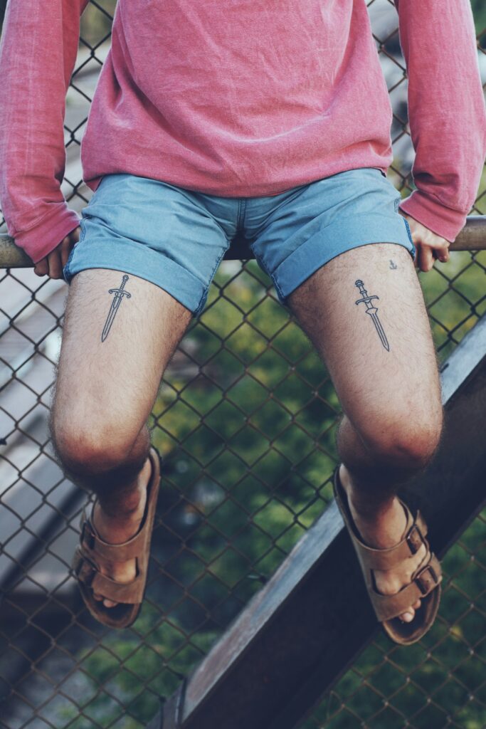 Leg tattoos for men: small crosses above both knees