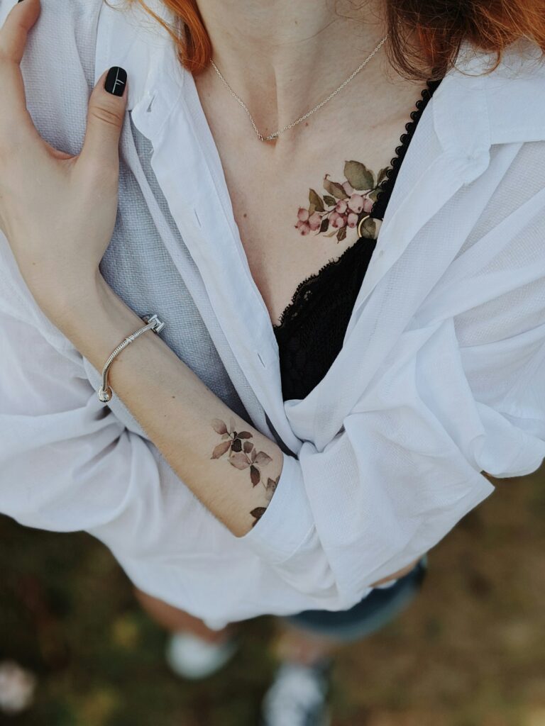 Small floral sternum tattoo on a woman