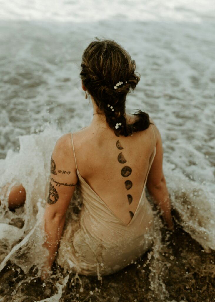 Script tattoo along the spine