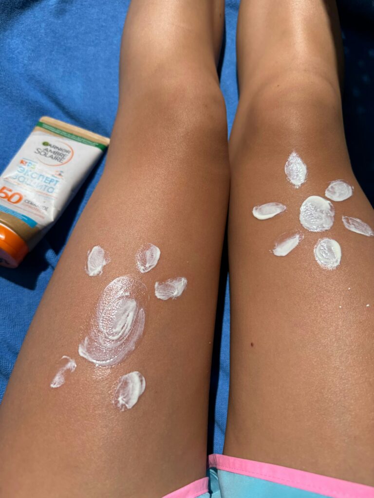 Sunscreen for tattoos: sunscreen drawn as sun shapes on legs at the beach