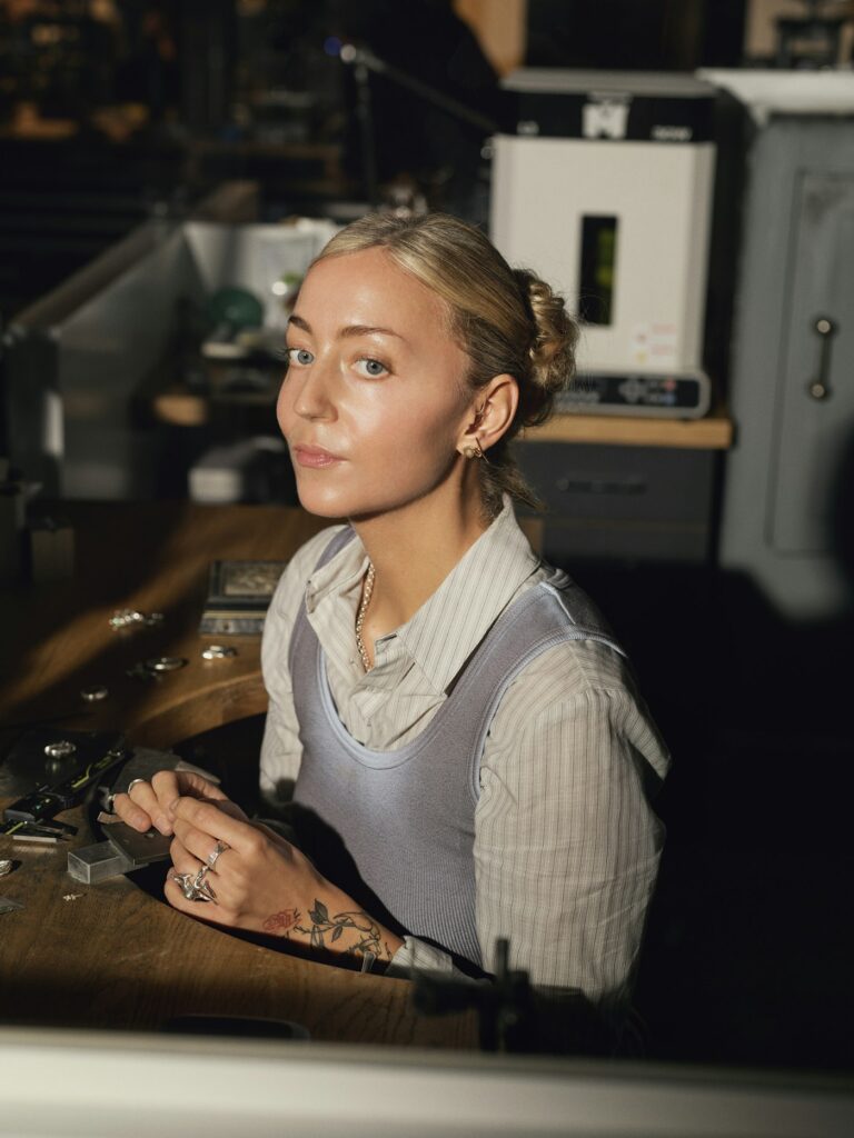 Tattoo artist at her workstation preparing for a session