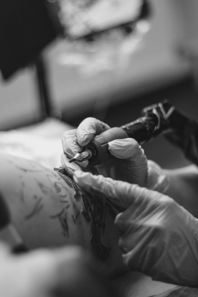 Tattoo cost depends on detail: close-up of a tattoo artist at work