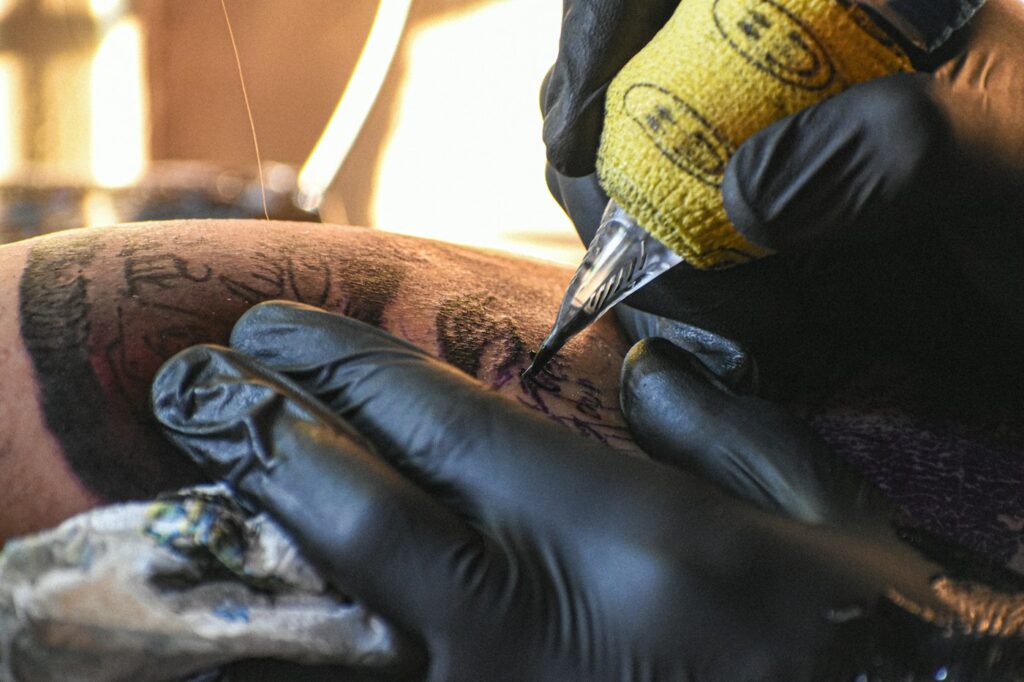 Tattoo blowout prevention: close up of a tattoo needle pulling linework into the skin