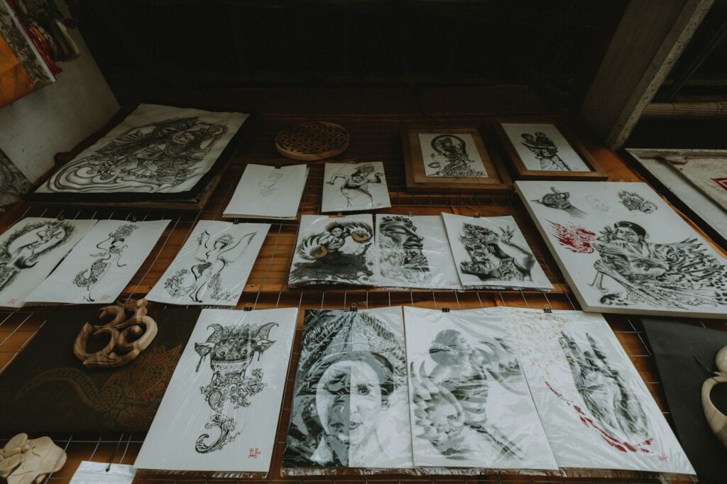 Collection of tattoo flash drawings laid out on a table