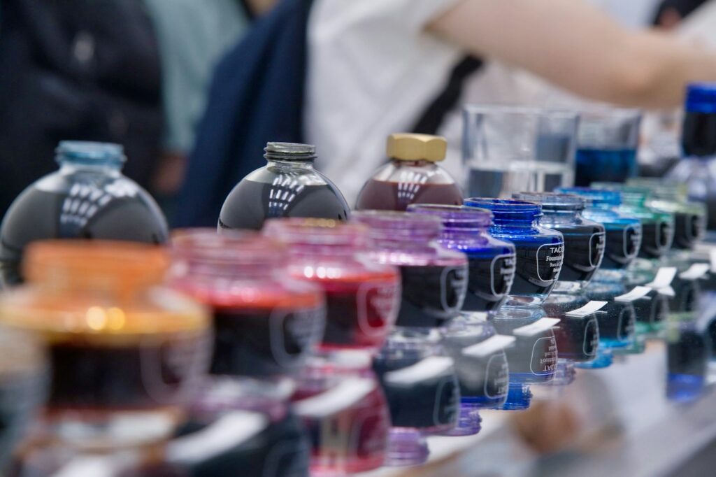 Tattoo ink: rows of colorful tattoo ink bottles on a studio table