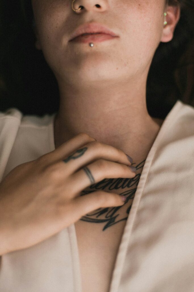 Tattoo on a woman's throat and hand