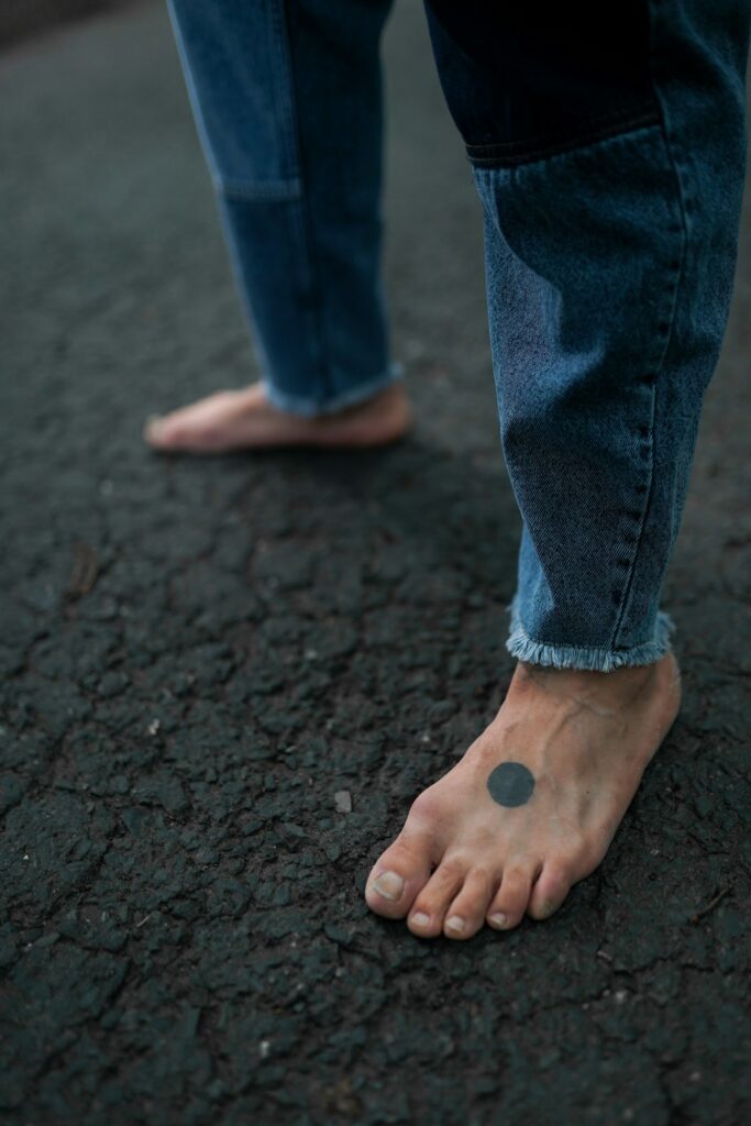 Foot tattoos for women: tiny minimalist symbol on the top of the foot
