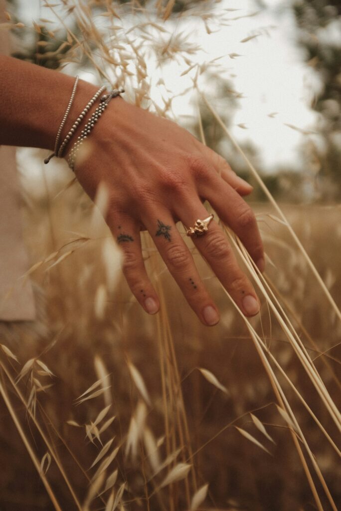 Tiny symbol tattoos on the fingers