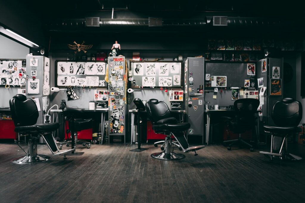 How much to tip a tattoo artist: interior of a tattoo studio with chairs and flash on the walls