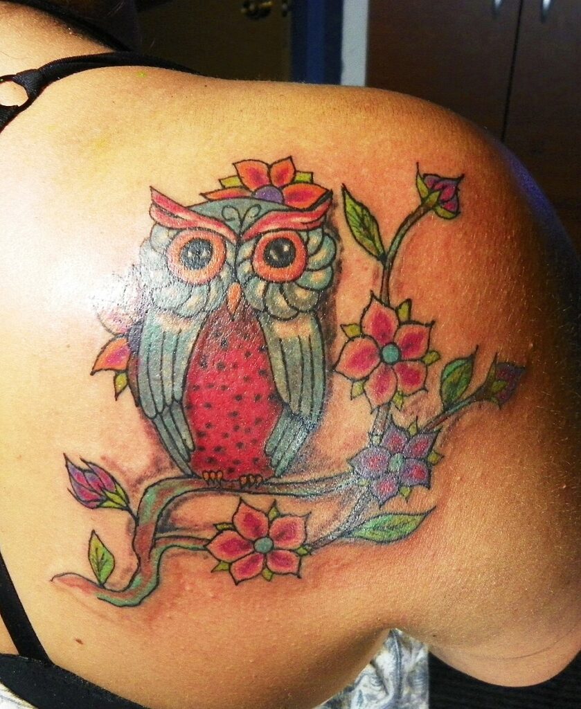 Traditional color owl tattoo with flowers
