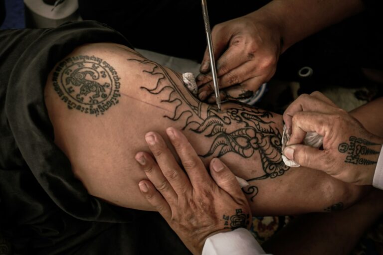 Tribal tattoo being made with the traditional hand tapping method