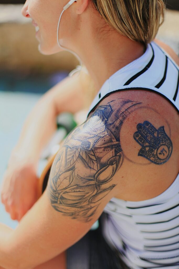 Upper arm and shoulder half sleeve on a woman in a striped top
