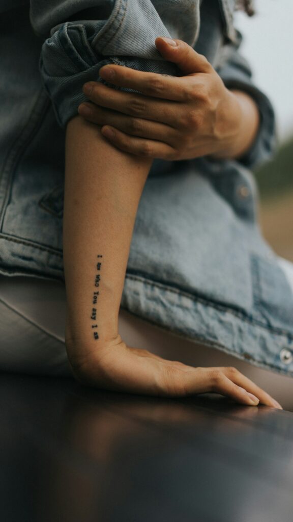 Vertical date tattoo on the inner arm