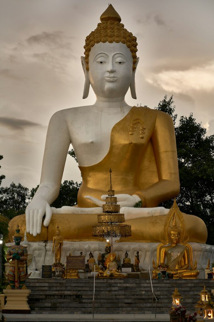 Seated white Buddha statue in meditation