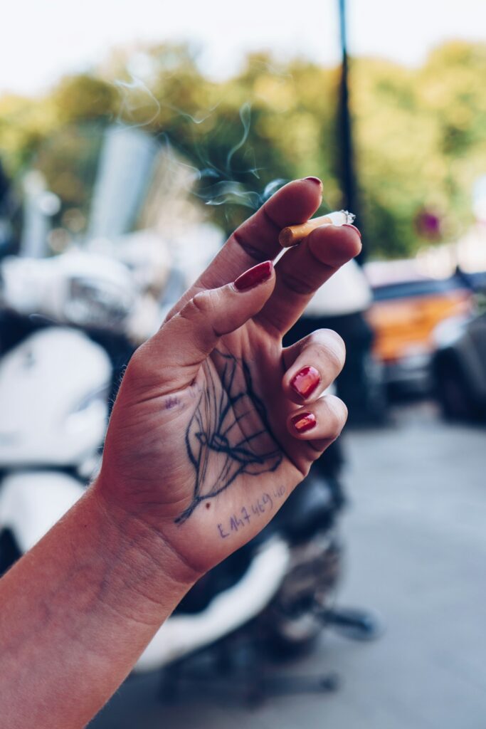 Woman's hand with line art tattoos
