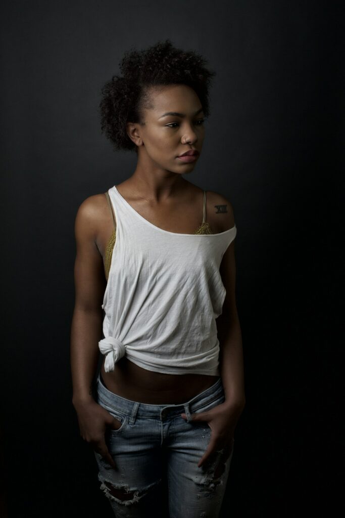 Woman with fine black tattoos on her arms and shoulder
