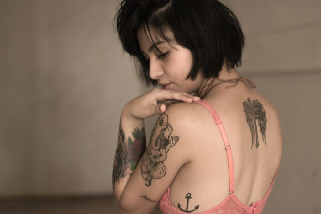 Woman with floral tattoos on her shoulder and arm