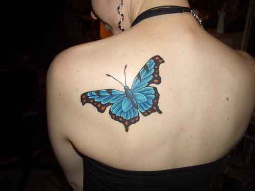 Blue butterfly tattoo on the shoulder blade
