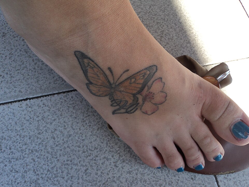 Shaded butterfly tattoo on the top of the foot