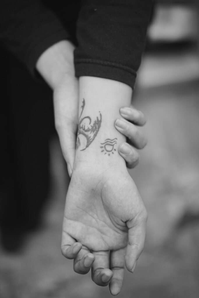 Fine line butterfly tattoo on the inner wrist
