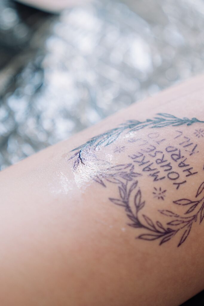 Fresh tattoo next to plastic wrap in a tattoo studio