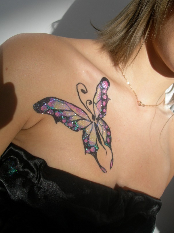 Temporary glitter butterfly tattoo on the chest