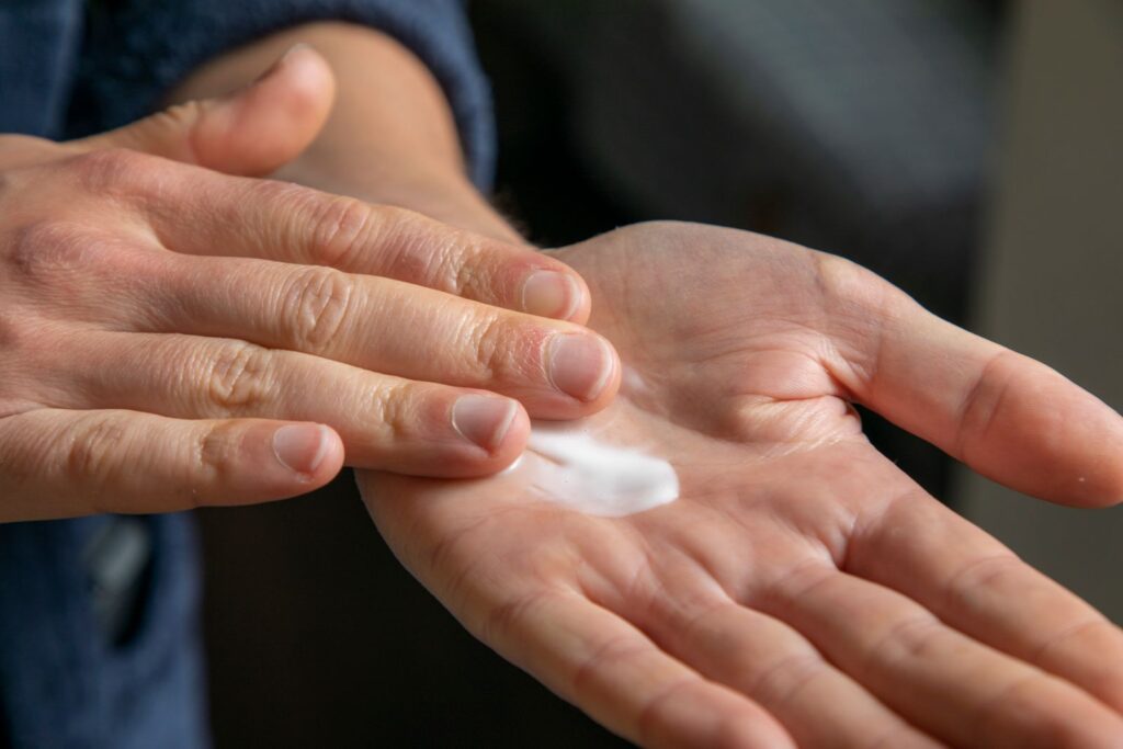 Hands rubbing in a healing cream