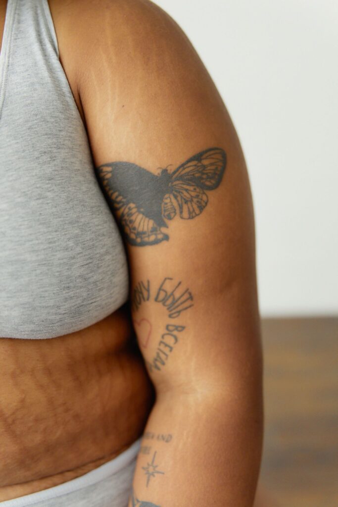Large shaded butterfly tattoo on the upper arm