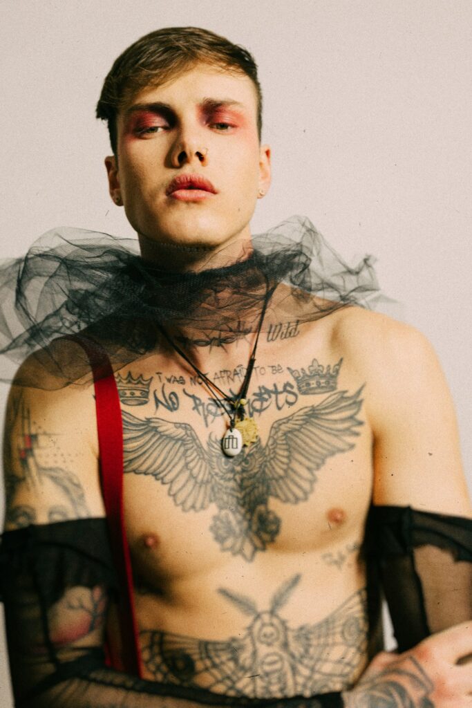 Man with a large moth tattoo across his chest