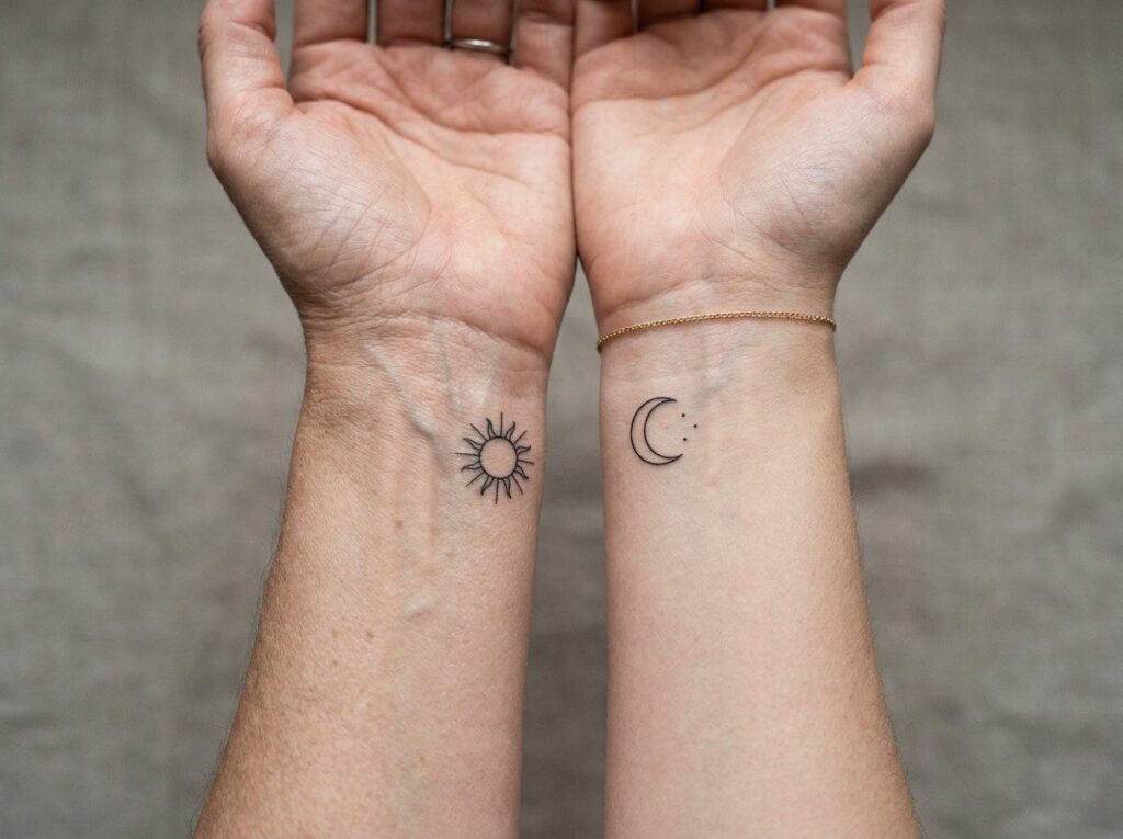 Mother daughter tattoos: sun and moon on the wrists side by side