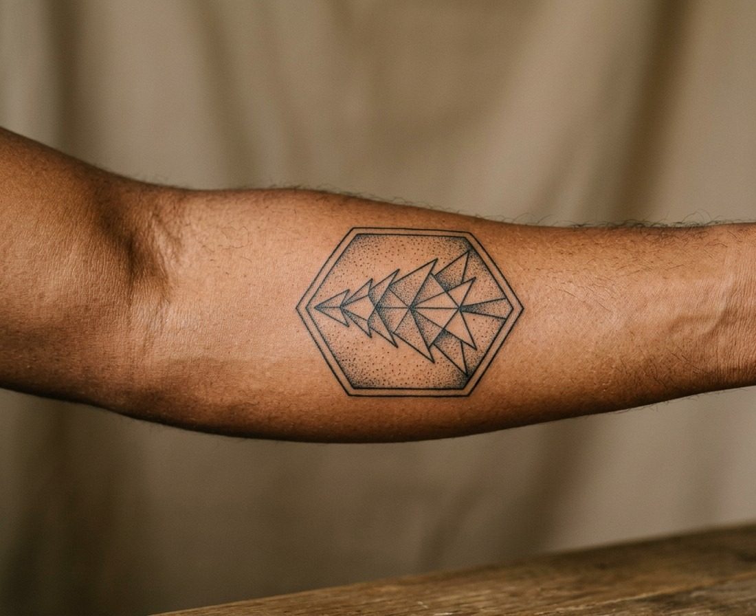 Pine tree tattoo: geometric pine tree on the outer forearm